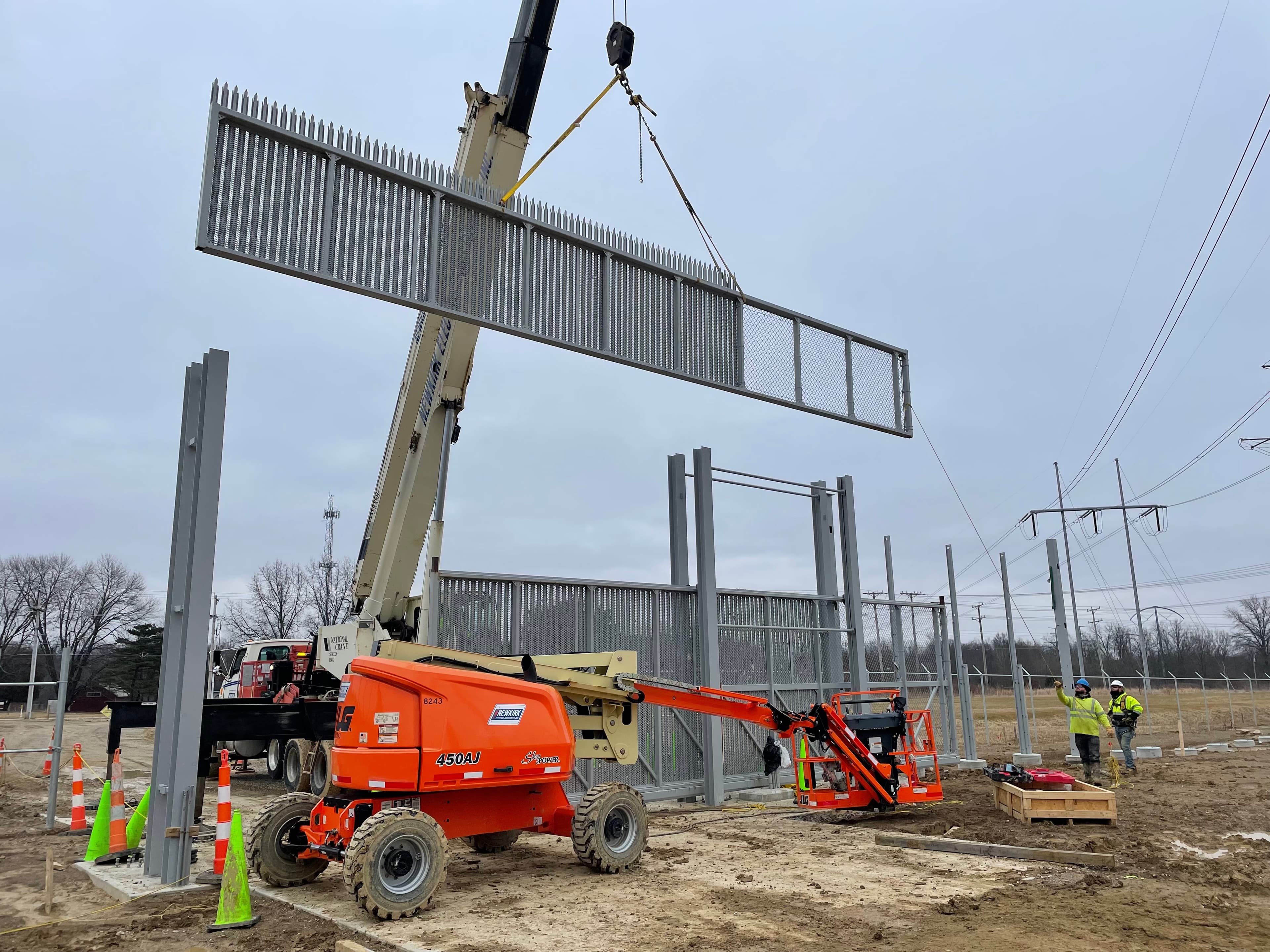 Bru-Hart team installing high-security fence with crane